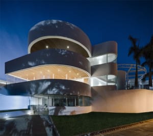 An image of a modern residential building with glass and concrete exterior materials.