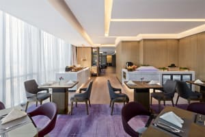 Modern interior of a restaurant featuring wood and marble materials and contemporary design elements