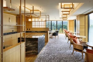 Hotel suite with modern interior design featuring wood and marble elements.