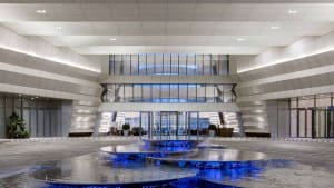 A modern office lobby featuring glass and stone materials.