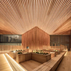 An industrial-style interior space with wooden materials and geometric lighting patterns.