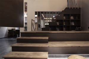 Modern minimalist living room with wooden furniture and concrete accents