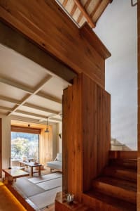 A modern minimalist residential interior with wooden elements.