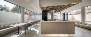 Modern cafe bar interior with concrete, marble, and wooden finishes