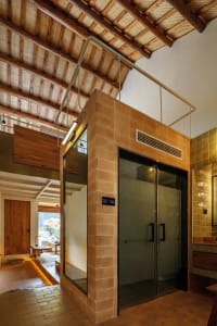Modern residential interior featuring brick, concrete, and tiled walls and floors.