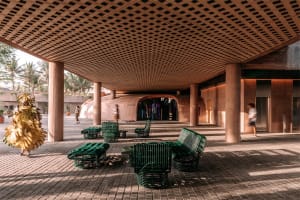 Industrial-style interior space featuring a wooden seat under a lattice ceiling.