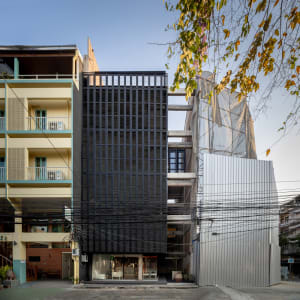 A modern urban building with metallic exterior and grid-like facade.