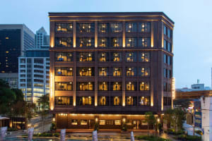 Modern office building exterior featuring glass, metal, and concrete materials.