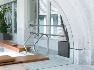 Industrial-style interior with metal railing and tiled floor.