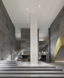A luxurious modern hotel lobby with marble finishes and sophisticated design elements.