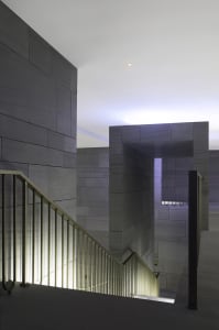 Image of a modern industrial luxury residential interior with stone and concrete materials.