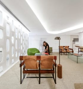 A modern office space featuring natural leather and wooden furniture.