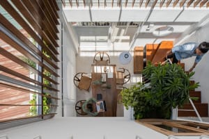 A modern industrial dining area featuring a wooden table, chairs, and concrete accents.
