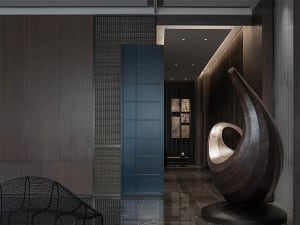 Contemporary lobby interior featuring a metallic abstract sculpture on a black pedestal.