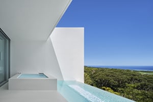 Modern residential patio featuring glass and concrete materials.