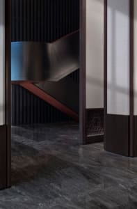 Modern staircase featuring marble and metal elements.