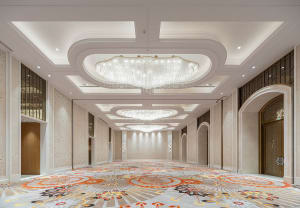 Spacious, modern banquet hall with marble accents and wooden paneling.