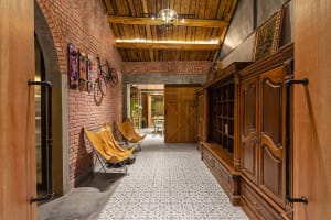 Industrial-style interior with wooden paneling and exposed brick walls.