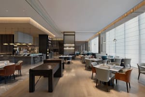 A modern restaurant interior with wooden floors, glass walls, metal accents, and leather seating.