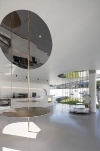 Modern coffee shop interior featuring minimalist design with metal and glass materials.