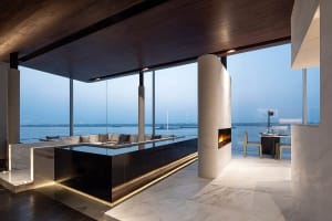 Modern living space with glass walls overlooking the sea