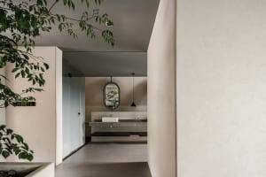 Modern minimalist bathroom featuring concrete flooring and glass walls.