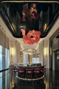 A stylish bar counter made of modern marble with red leather stools.
