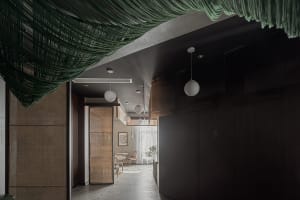 Contemporary restaurant interior with greenery accent and wooden decorative panels.