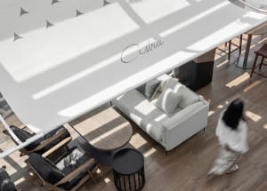 A modern spa suite featuring minimalist design, wood furniture, fabric seating, and glass elements.