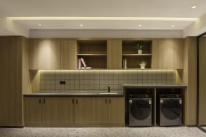 Well-organized laundry room with modern wooden cabinets and storage solutions.