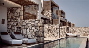 A minimalist residential exterior featuring stone and wood materials.