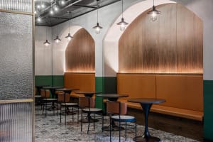 Modern cafe interior with booth seating featuring wooden accents and leather upholstery