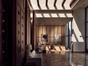 Modern lobby interior with marble flooring, white sofas, and abstract paintings on the wall.