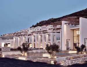 Modern hotel resort with white concrete architecture and stone ground pool.