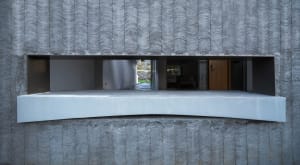 Modern building with concrete exterior featuring a minimalist design.
