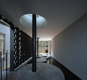 A modern interior design featuring a combination of concrete and glass materials.