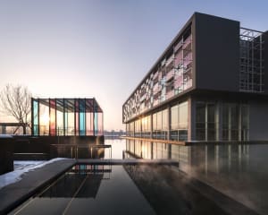 Modern architectural building exterior made of glass and metal.