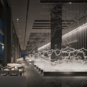 A modern restaurant interior featuring a metal, glass, and cloud-structured design with tables and chairs.