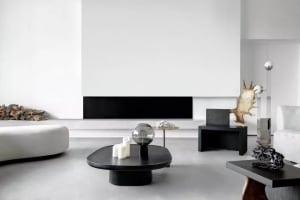 Modern minimalist living room with concrete floor, metal and wood furniture, and sleek black accents.