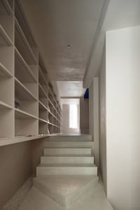 Modern concrete staircase interior with minimalistic design and natural lighting.
