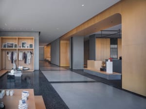 Modern hotel lobby featuring sleek concrete and wooden features.