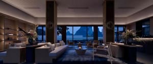 A modern living room with minimalist furniture, large windows, and a central coffee table.