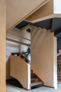 A modern architectural design featuring wooden stairs.