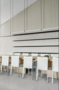 Modern restaurant interior with white leather chairs and wooden tables