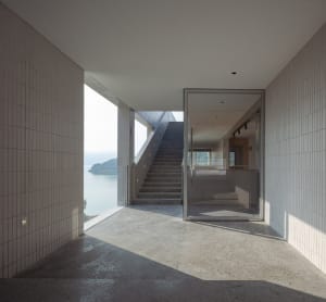 Interior design featuring modern, minimalist space with concrete walls and floor.