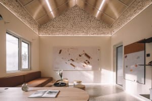 Industrial-style interior design featuring brick, wood, and concrete materials.