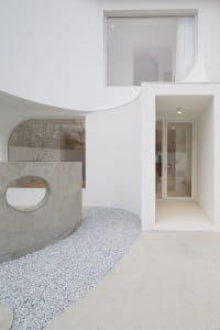 A modern exterior featuring concrete materials and minimalist design elements.