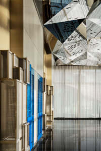 Modern hotel lobby featuring glass, metal, and marble materials