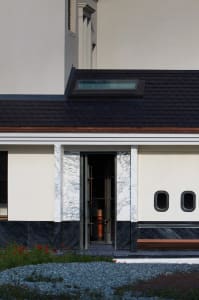 Modern minimalist building entrance featuring marble materials.