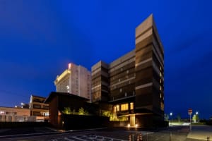 Modern commercial building with concrete and glass exterior at dusk
